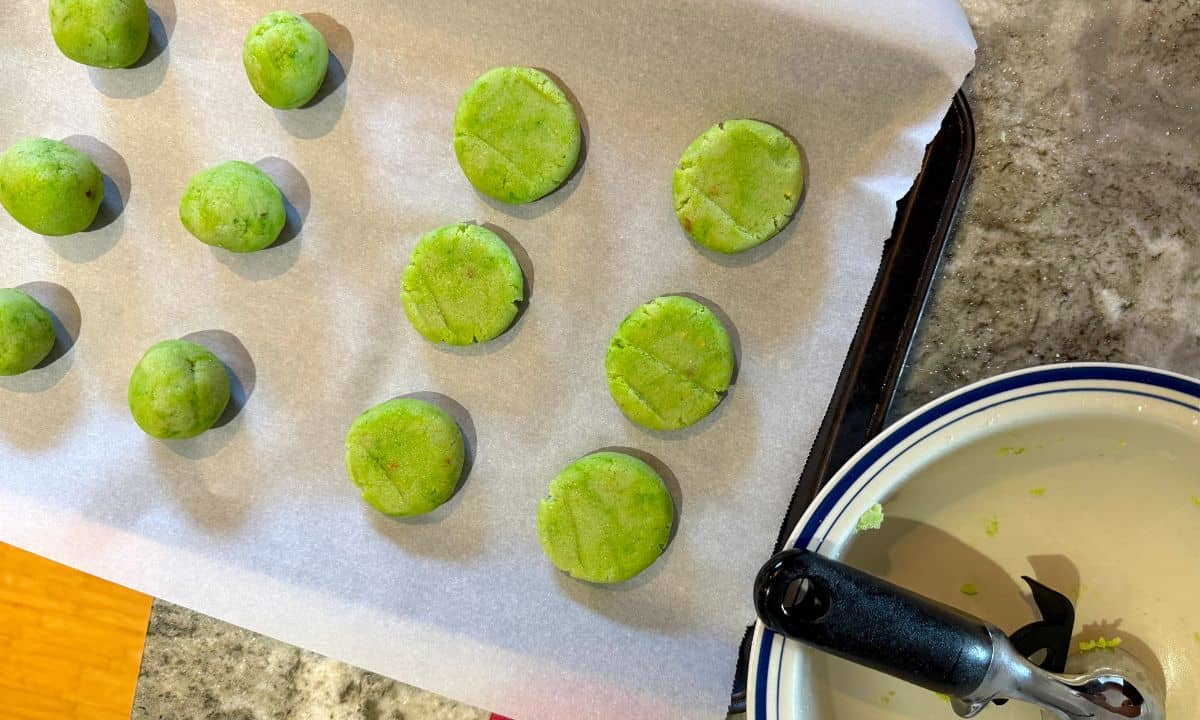 Making the low carb grinch cookies, rolled on a cookie sheet.