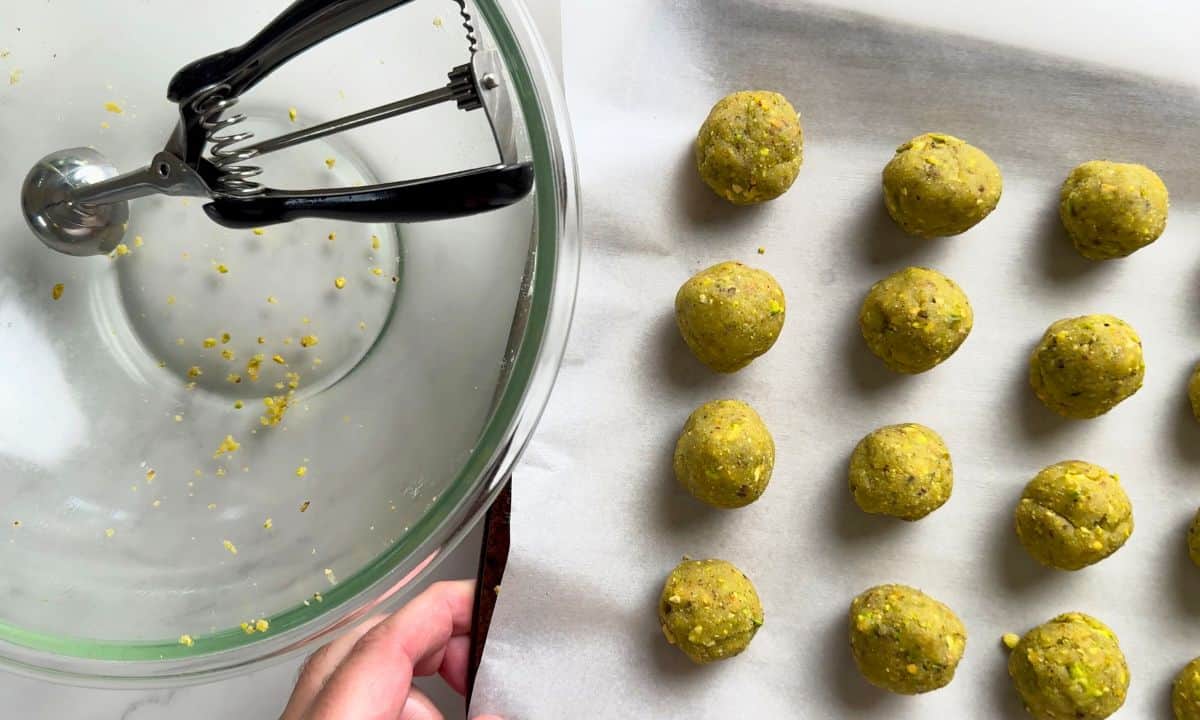 Low carb pistachio cookies on a parchment lined baking tray.