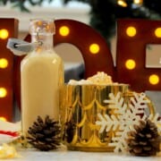 Low carb eggnog coffee creamer in a mug next to a bottle of the dairy free creamer.