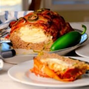 Low carb jalapeno popper meatloaf on a platter with a slice on a plate.