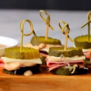 Low carb reuben pickle bites on a cutting board.