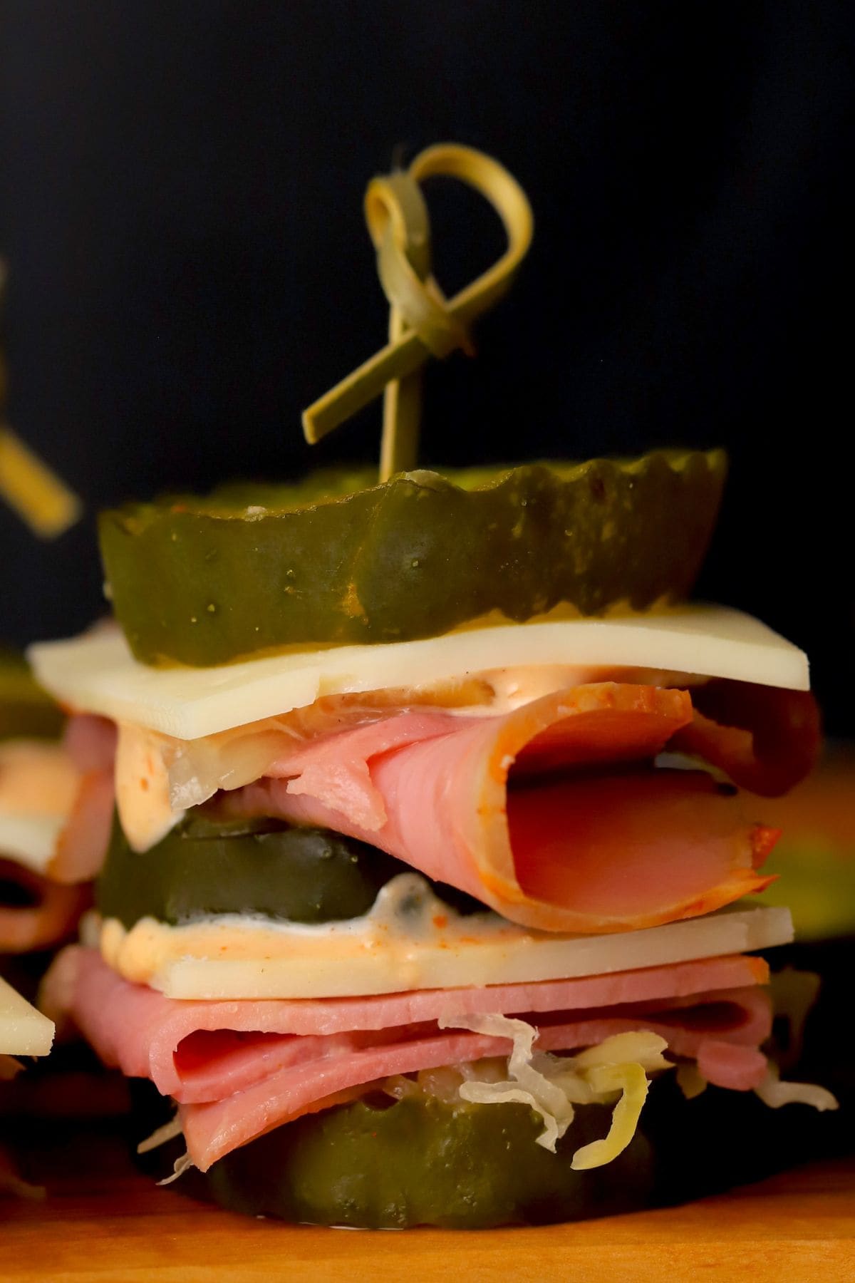 Closeup of a low carb reuben pickle bite on a cutting board.