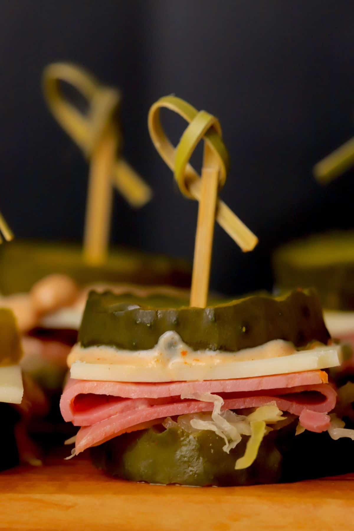 Low carb reuben pickle bites on a cutting board.