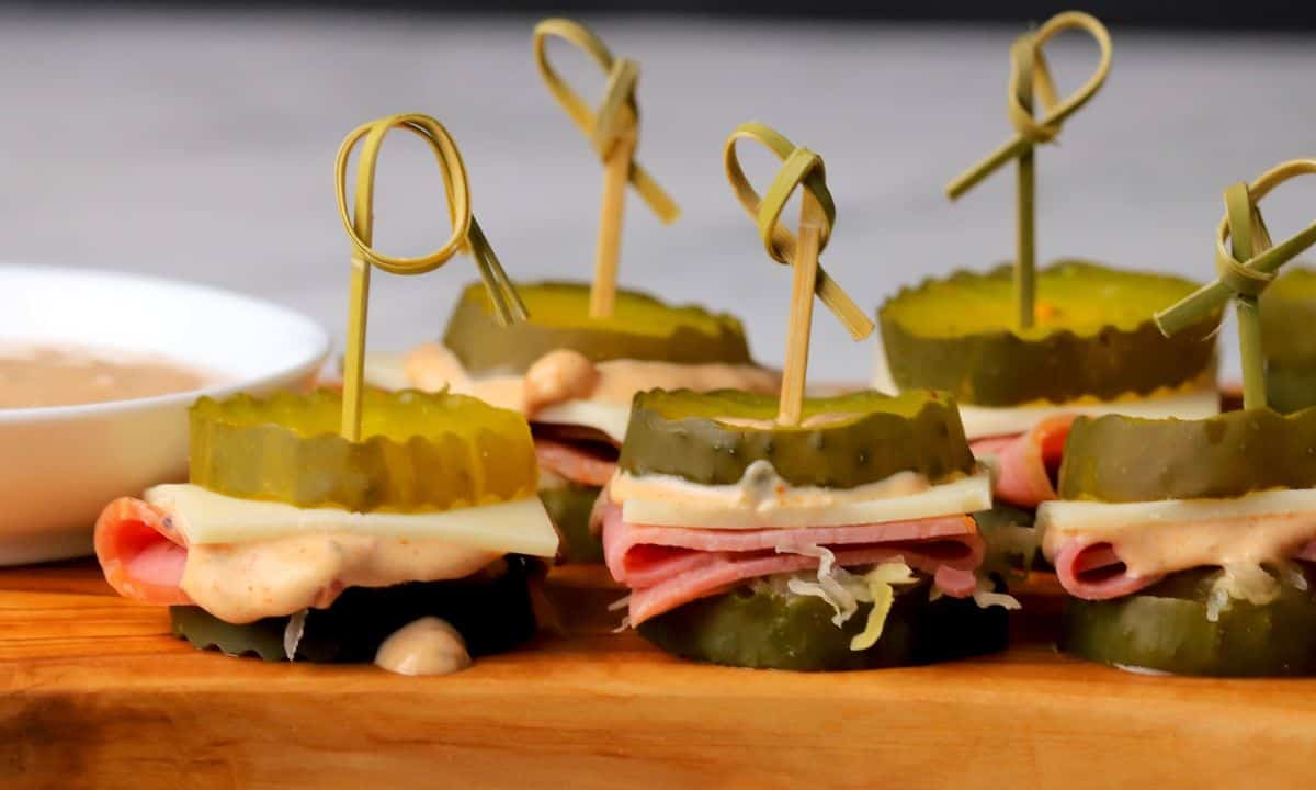 Low carb reuben pickle bites on a cutting board.