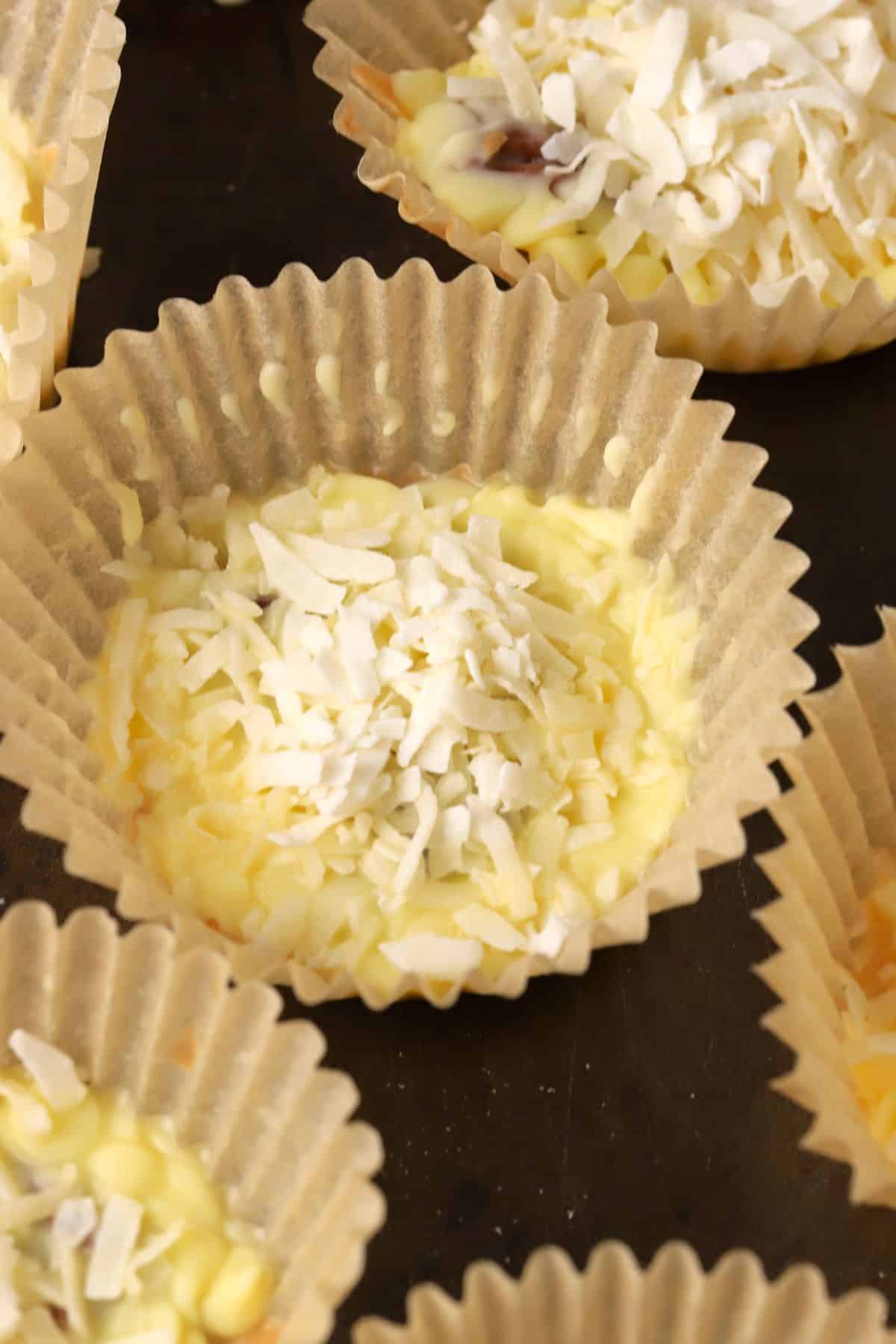 Close up of low carb white chocolate pecan coconut cluster on a sheet pan.