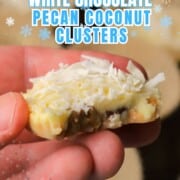 Holding a low carb white chocolate pecan coconut cluster.
