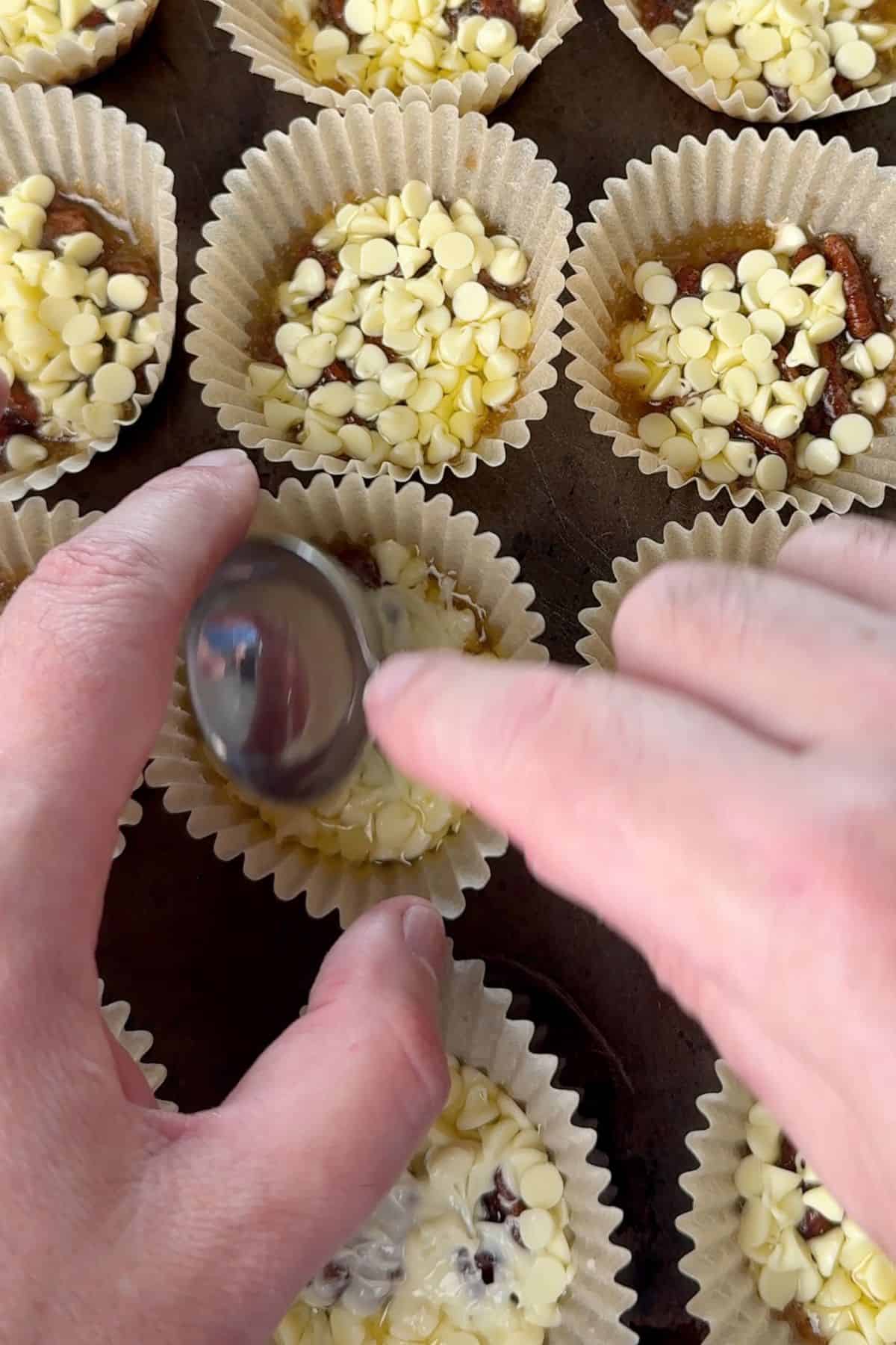 Smoothing out the melted white chocolate.