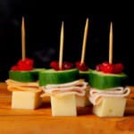 Turkey cranberry skewers appetizers on a cutting board.