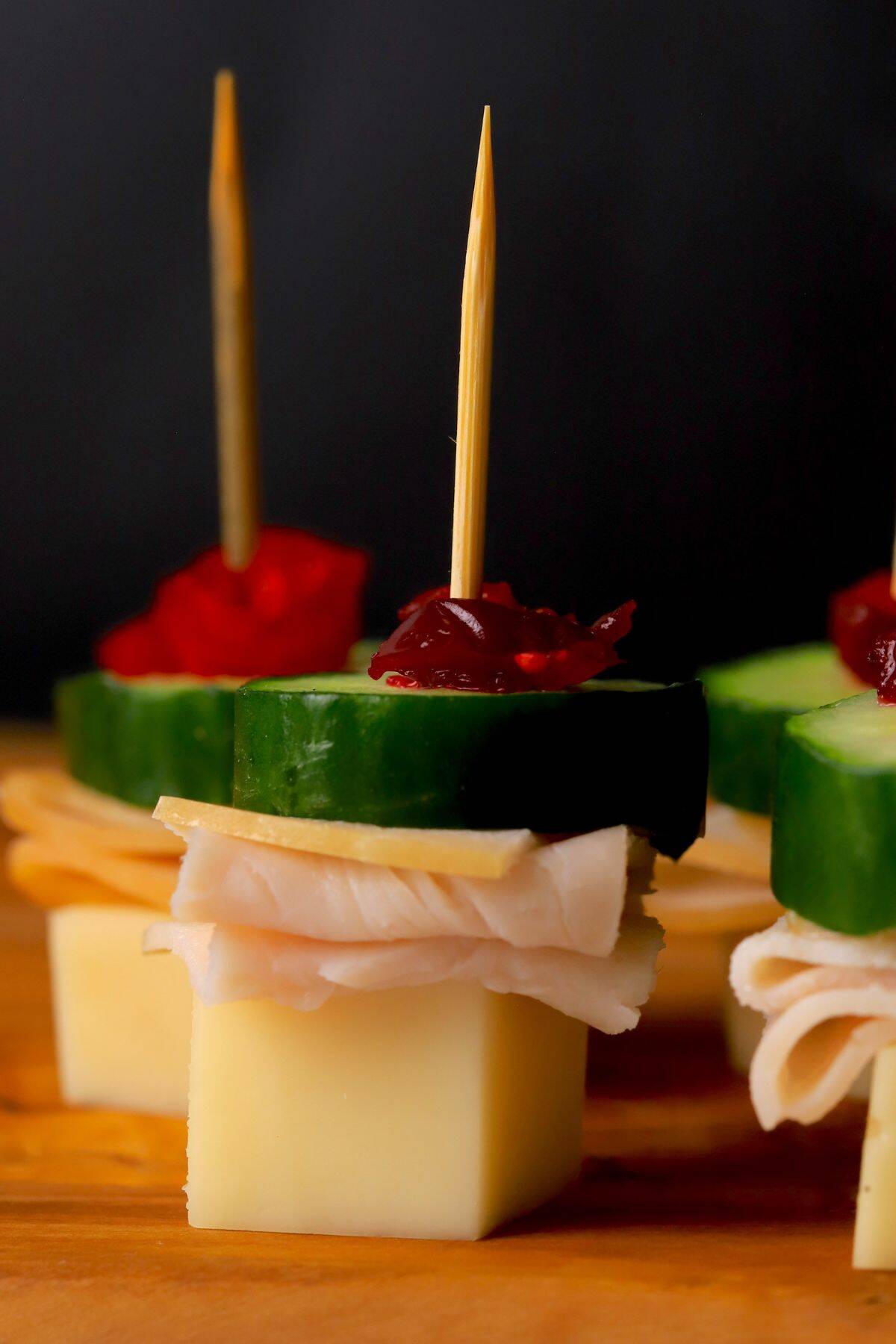 Turkey cranberry skewers appetizers on a cutting board.