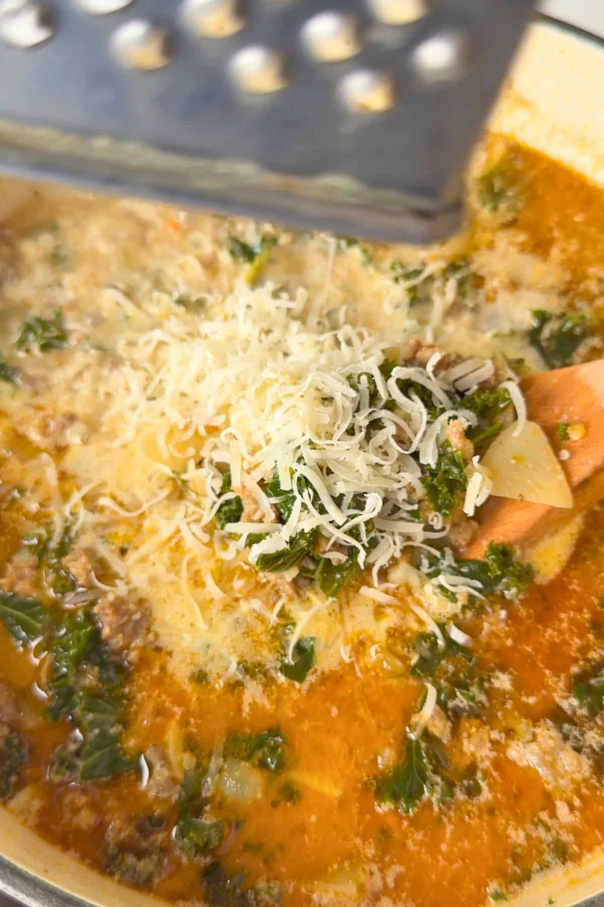 Adding the parmesan cheese to the soup.
