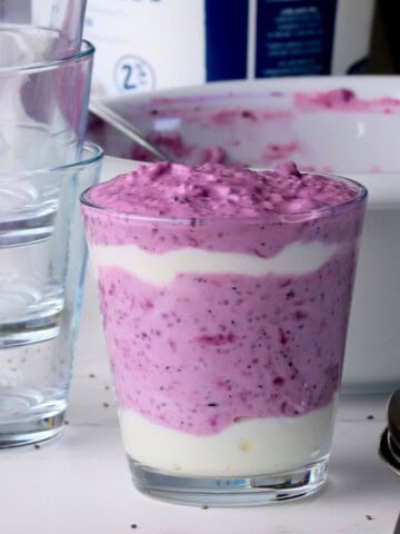 Blueberry chia seed pudding in a glass cup.