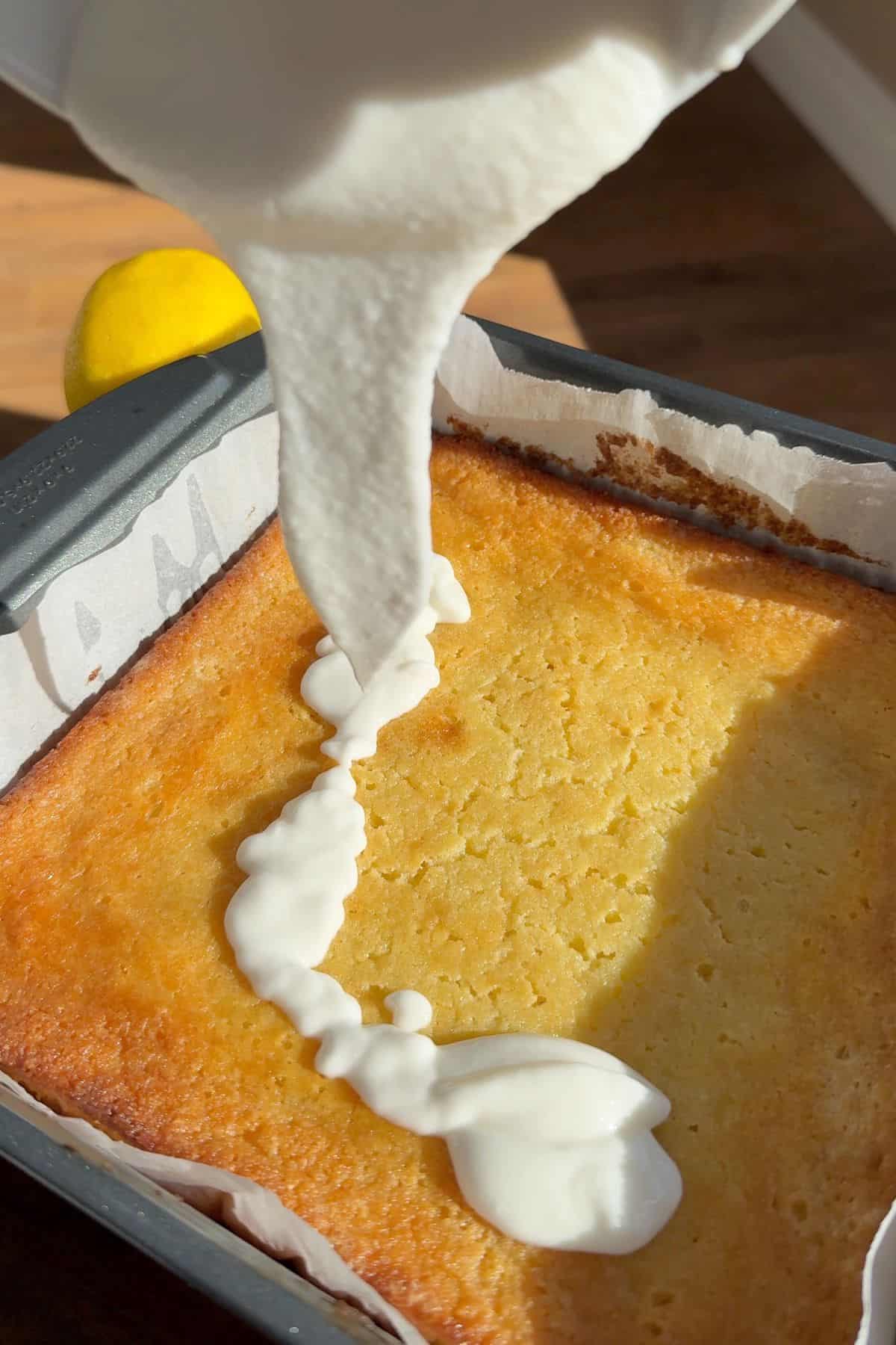 Adding the icing to the cake.