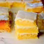 Three low carb lemon brownies stacked on top of each other.