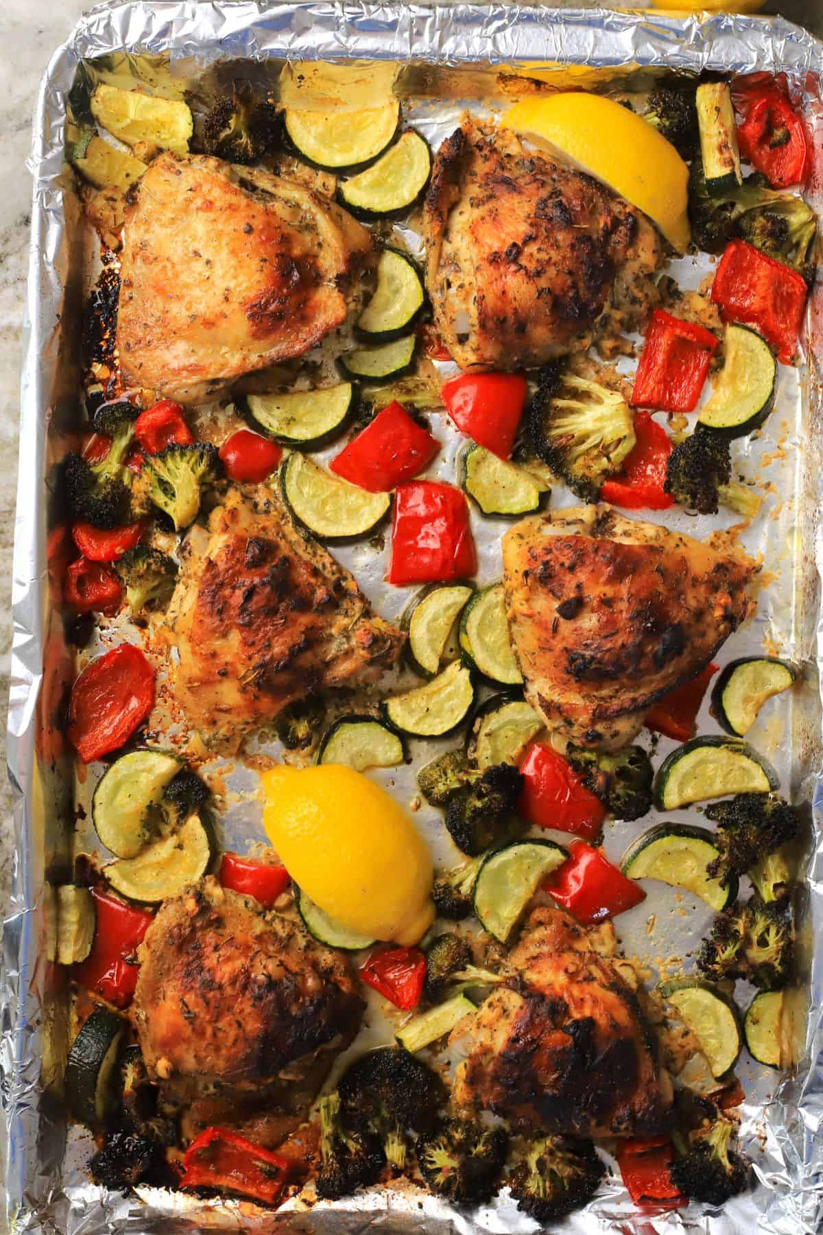 Low carb lemon garlic chicken with vegetables on a sheet pan.