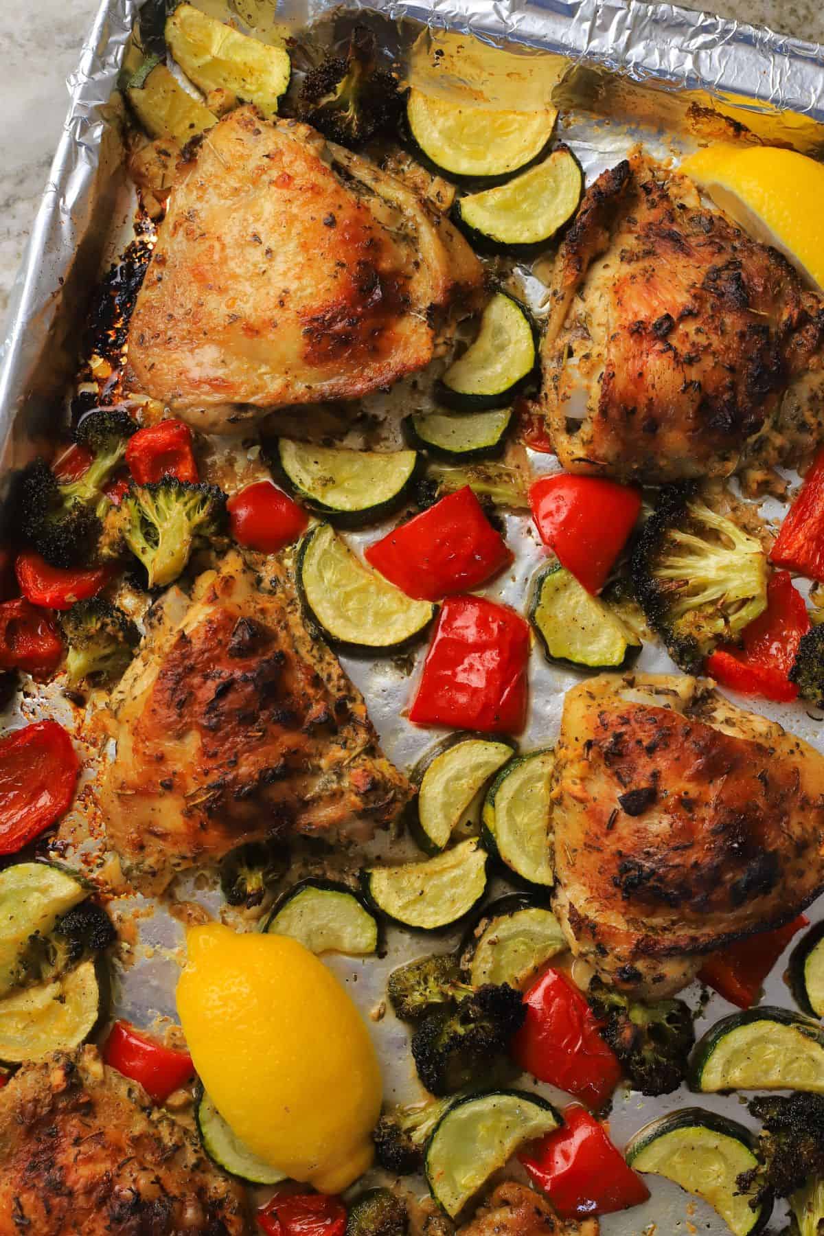 Low carb lemon garlic chicken with vegetables on a sheet pan.