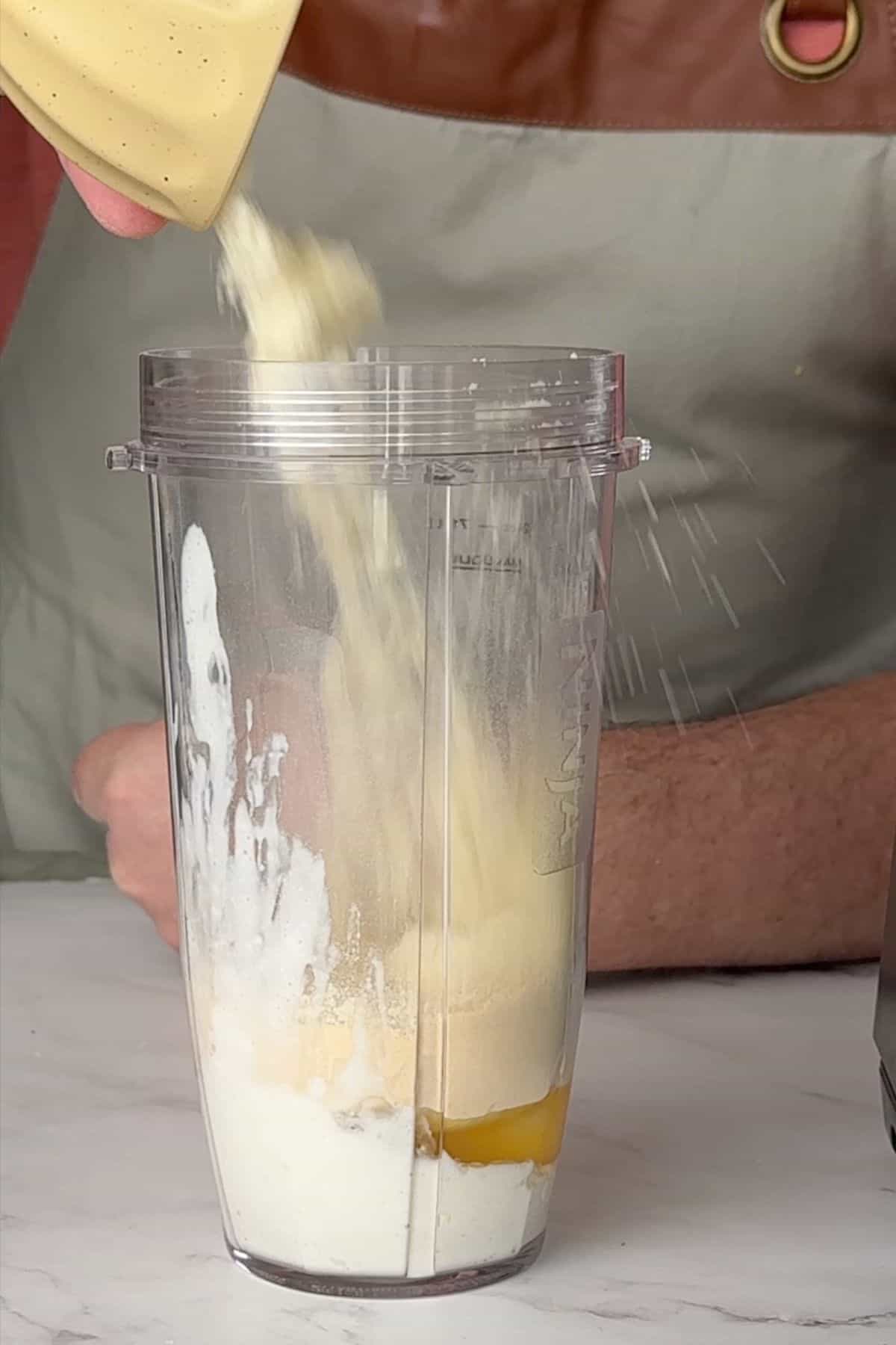 Adding ingredients to a blender.