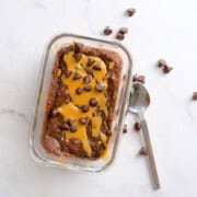 Cottage cheese chocolate protein mug cake drizzled with peanut butter and topped with chocolate chips.