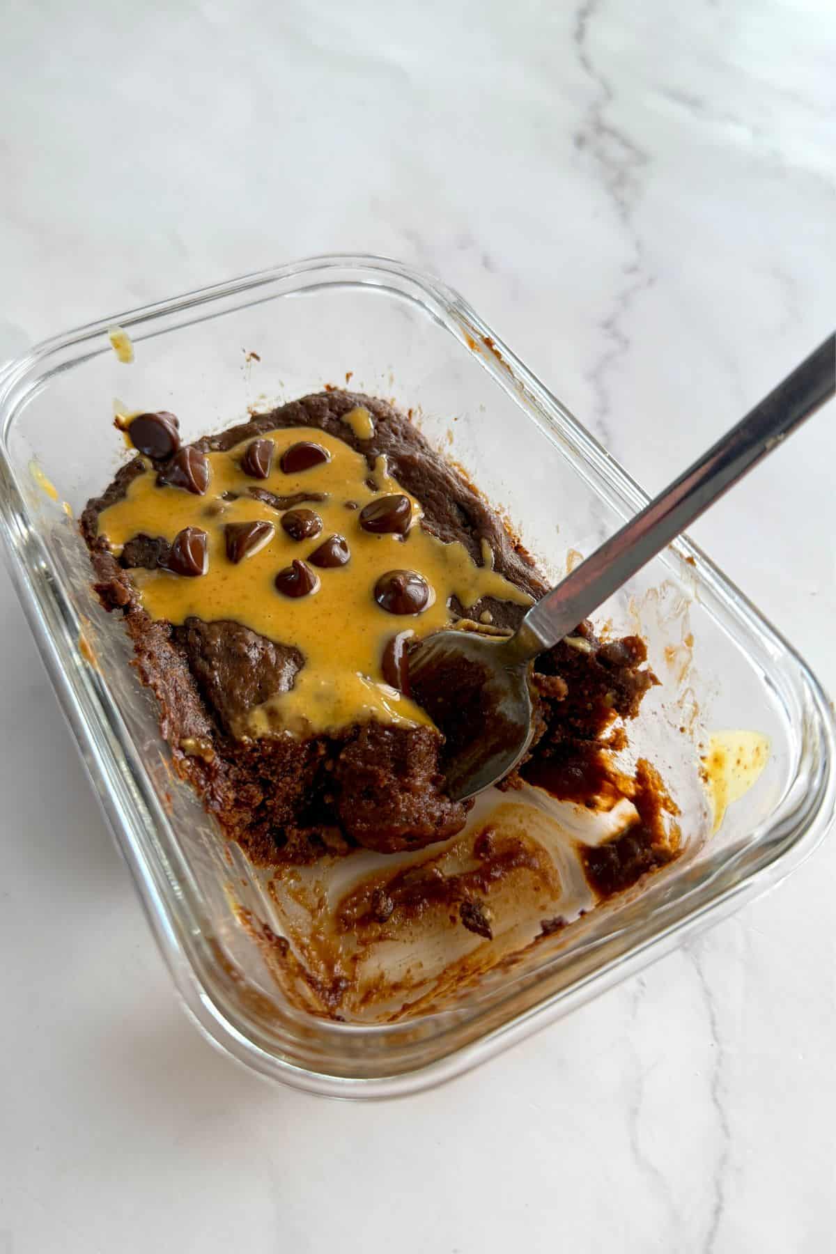 A spoon digging into the protein mug cake.
