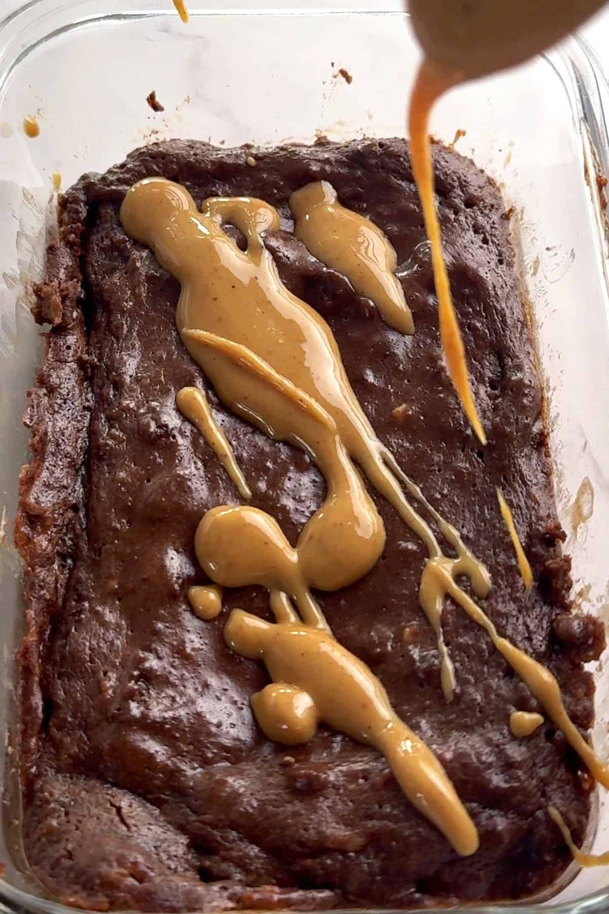 Drizzling peanut butter over the protein mug cake.