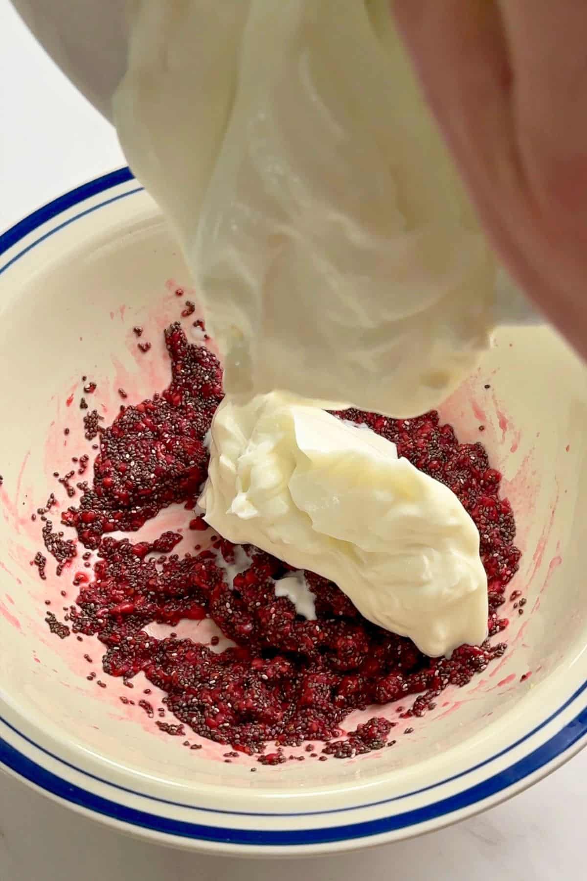 Adding greek yogurt to the raspberry mixture.