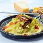 Low carb cabbage alfredo with chicken and bacon on a plate.