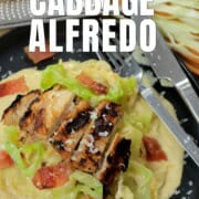 Low carb cabbage alfredo with chicken and bacon on a plate.