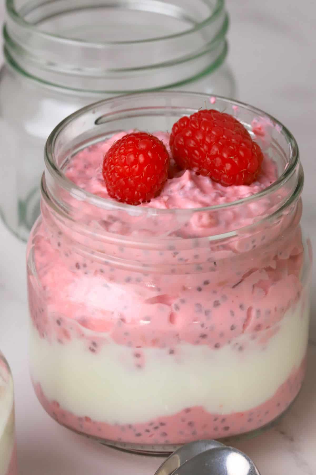 Low carb raspberry chia pudding in a mason jar.