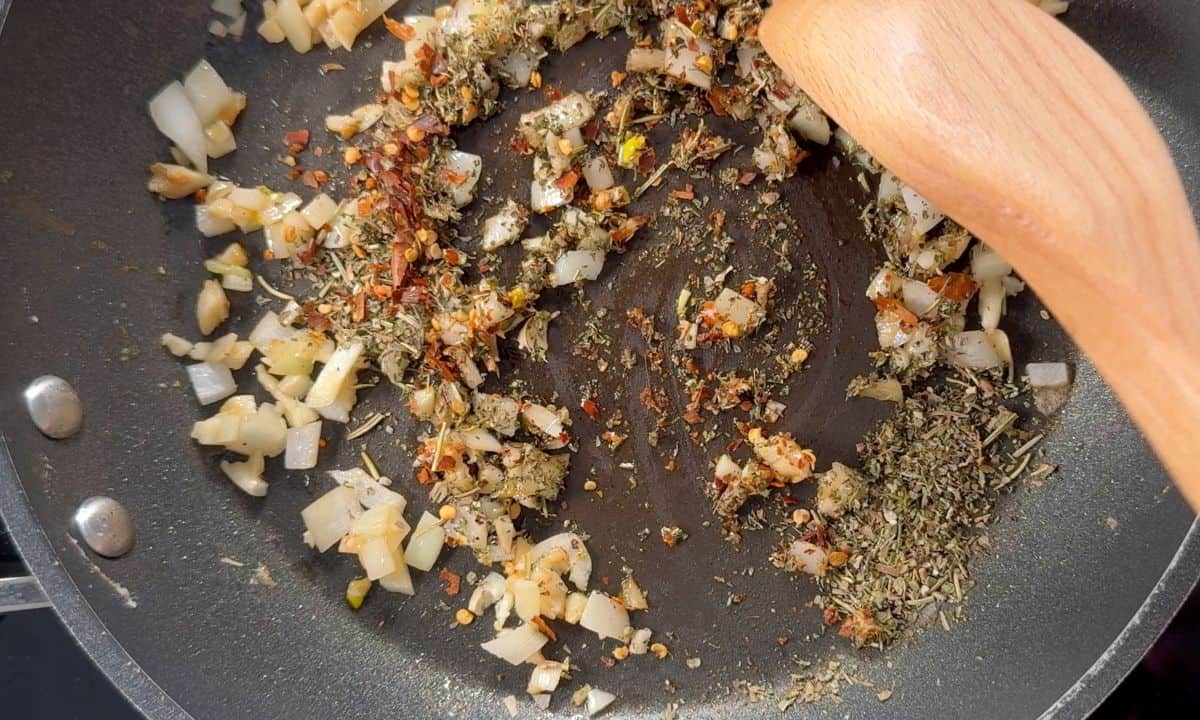 Garlic, onion and spices sauteeing in a pan.