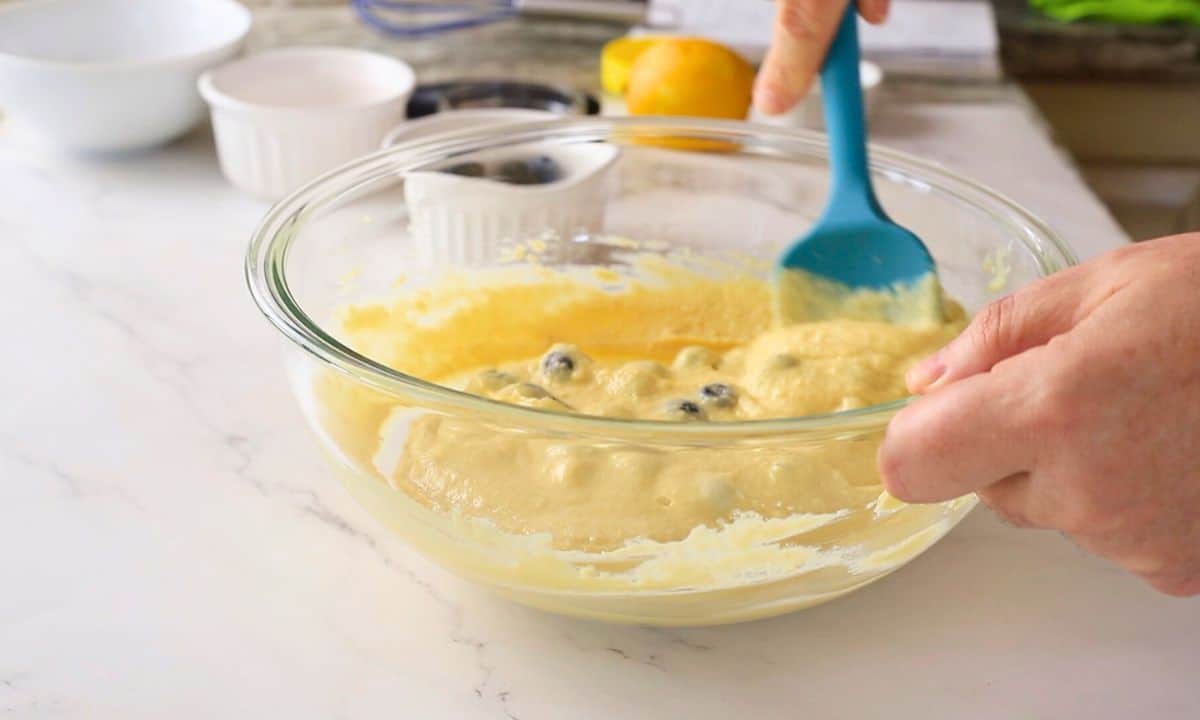 Folding the blueberries into the batter.