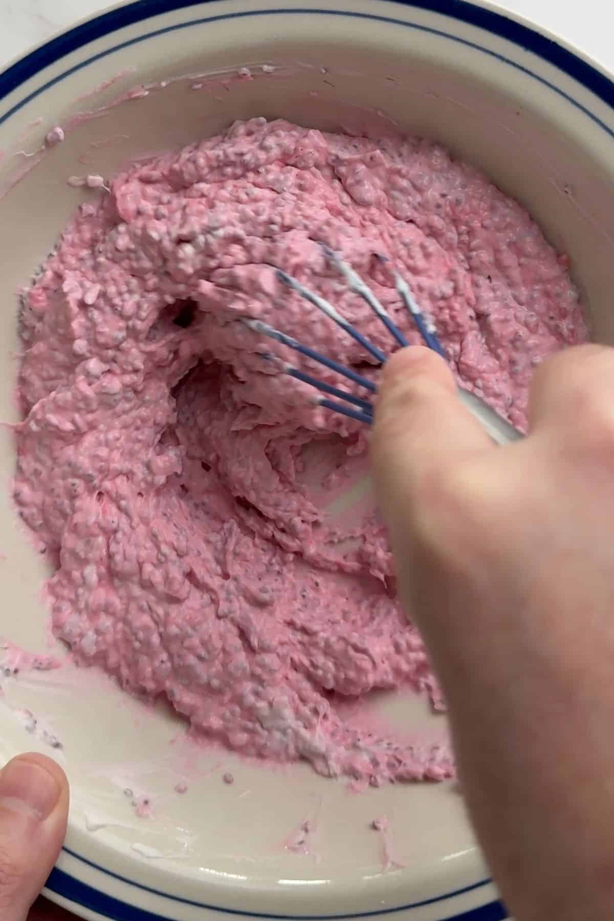 Whisking the greek yogurt with the chia raspberry jam.