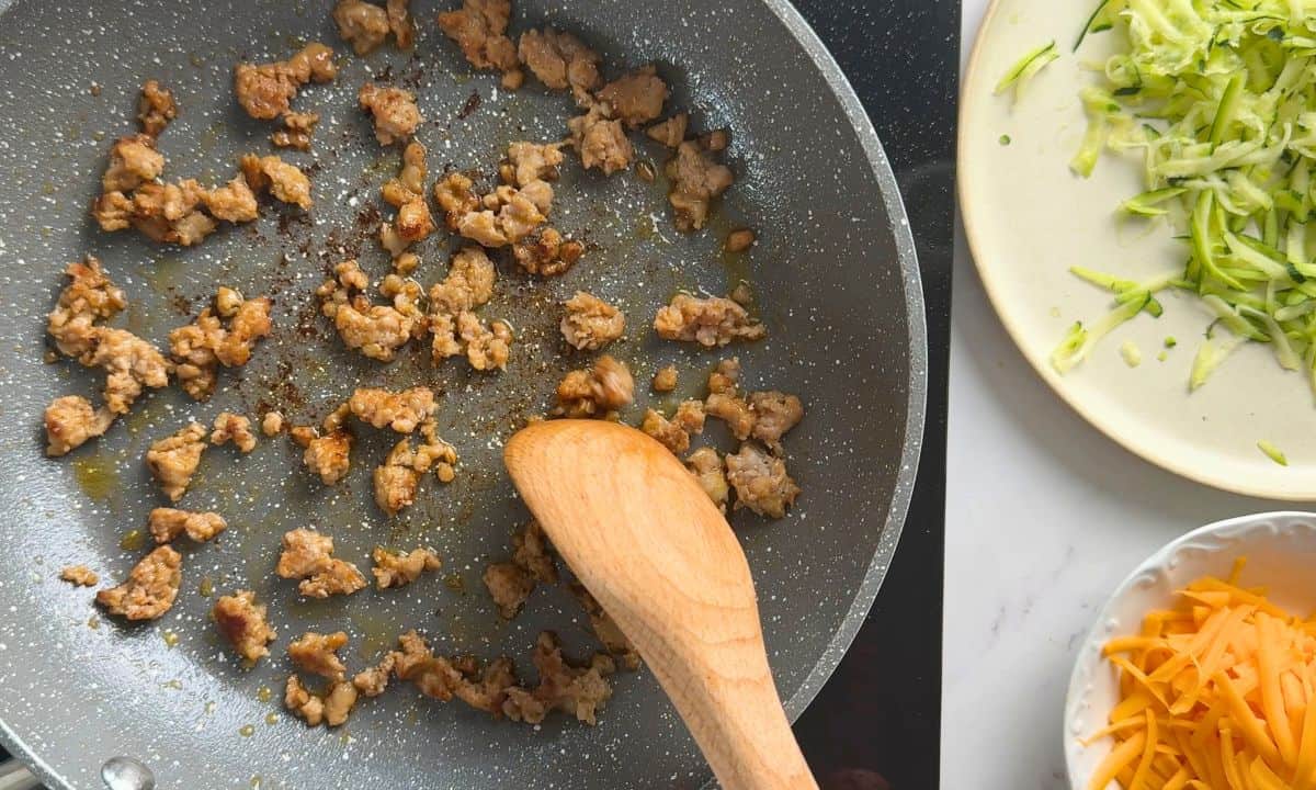 Browning the sausage in the pan.
