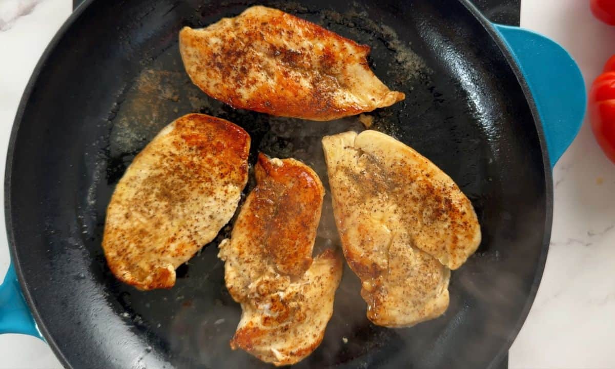 Chicken cooking in the skillet.