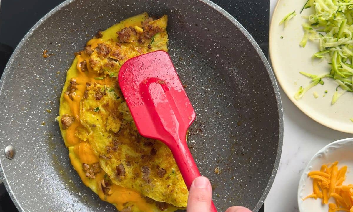 Flipping the omelette in the pan.