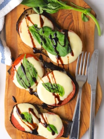 Low carb caprese eggplant on a cutting board.