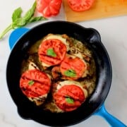 Low carb pesto caprese chicken in a skillet.