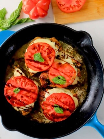 Low carb pesto caprese chicken in a skillet.