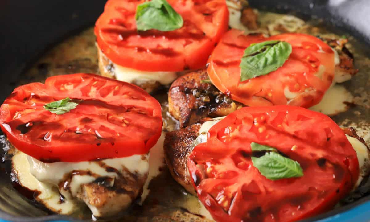 Close up shot of the pesto caprese chicken in the skillet.