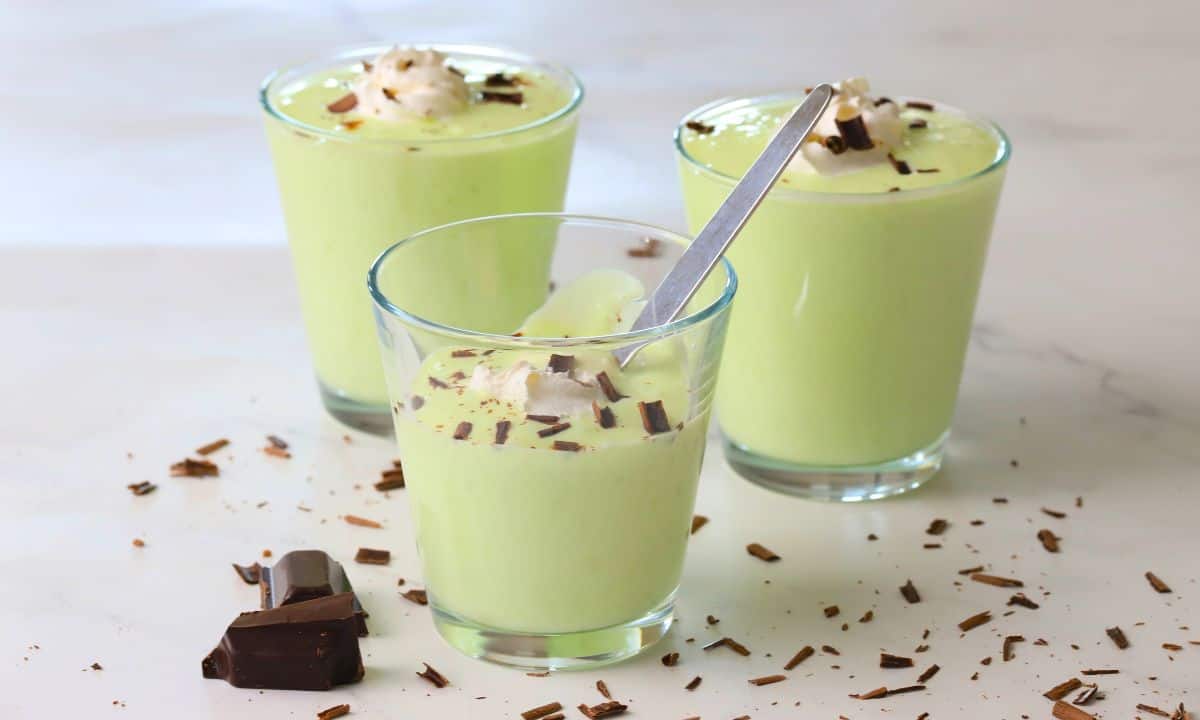 Three cups filled with the low carb shamrock shake pudding.