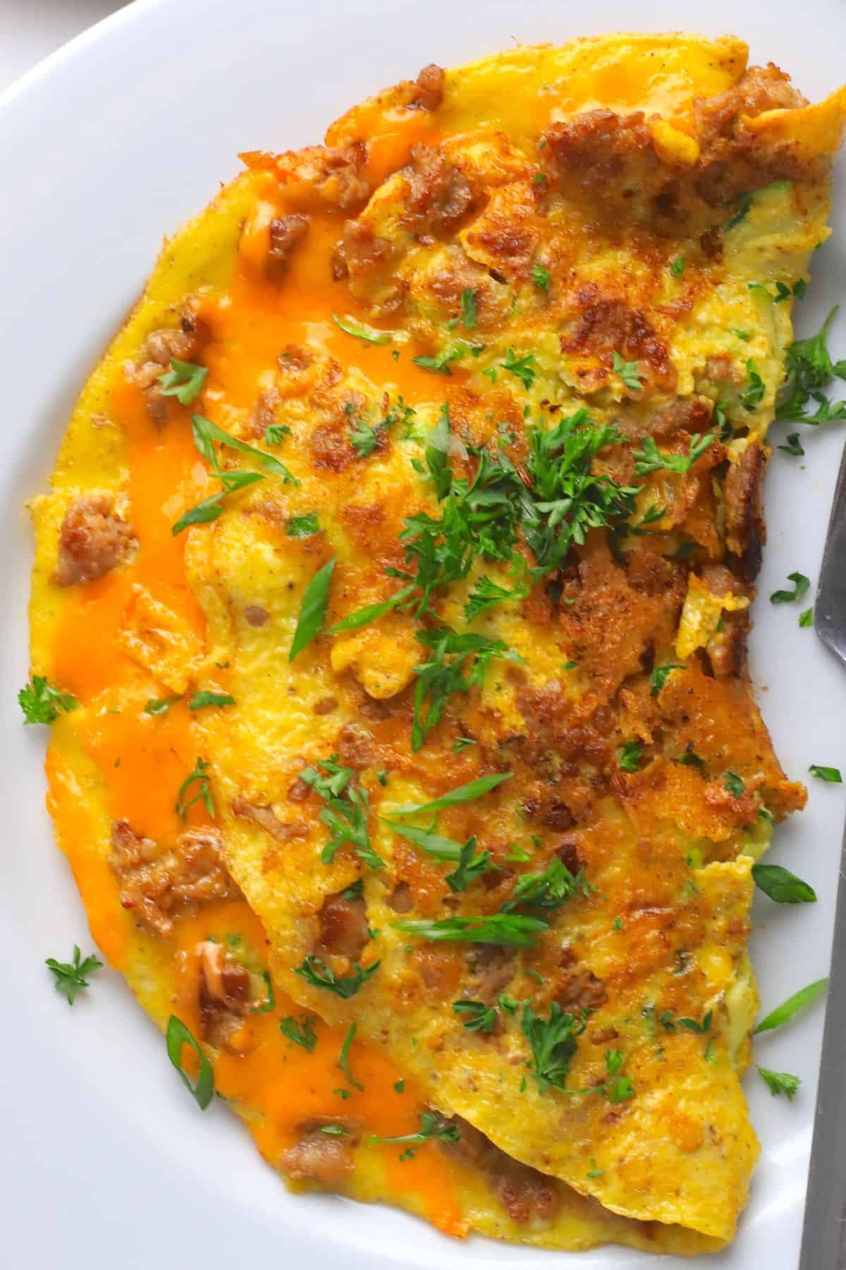 Closeup of low carb zucchini sausage omelette on a plate.