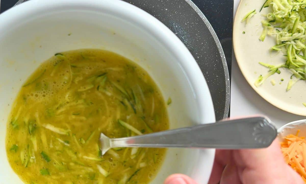 Whisking the eggs with zucchini.
