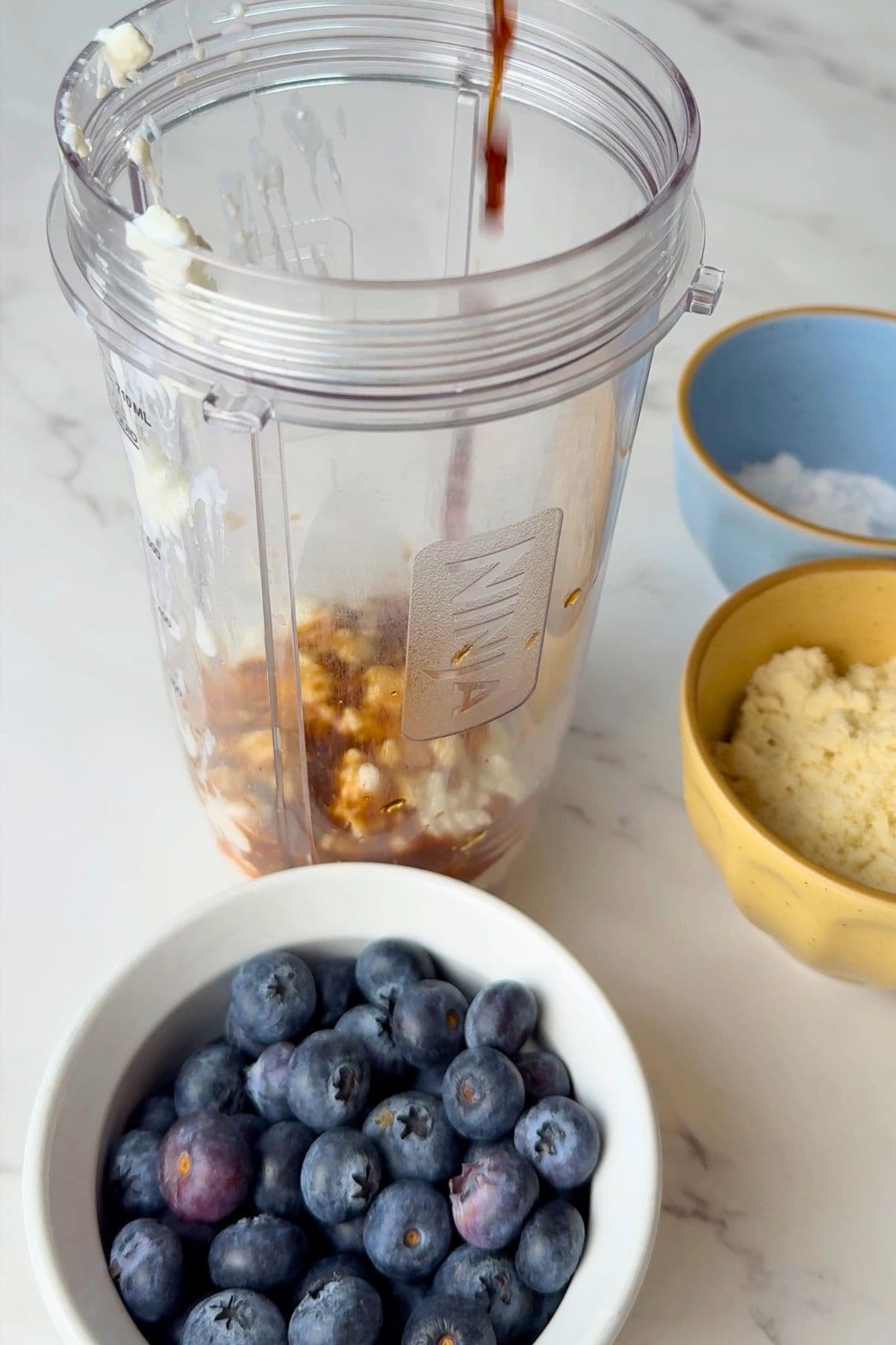 Adding ingredients to the blender cup.
