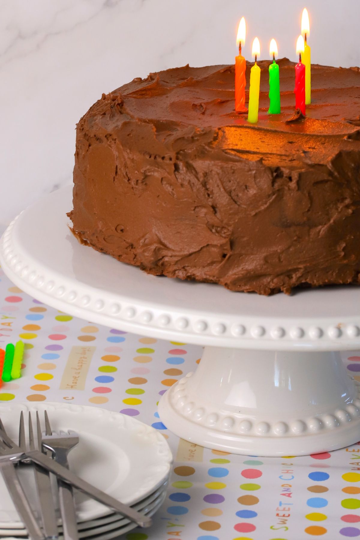 Diabetic chocolate birthday cake with candles burning.