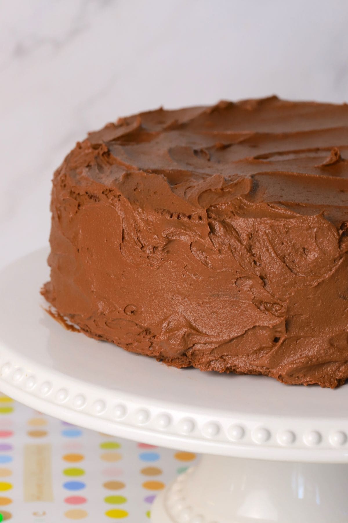 Diabetic chocolate birthday cake on a cake stand.