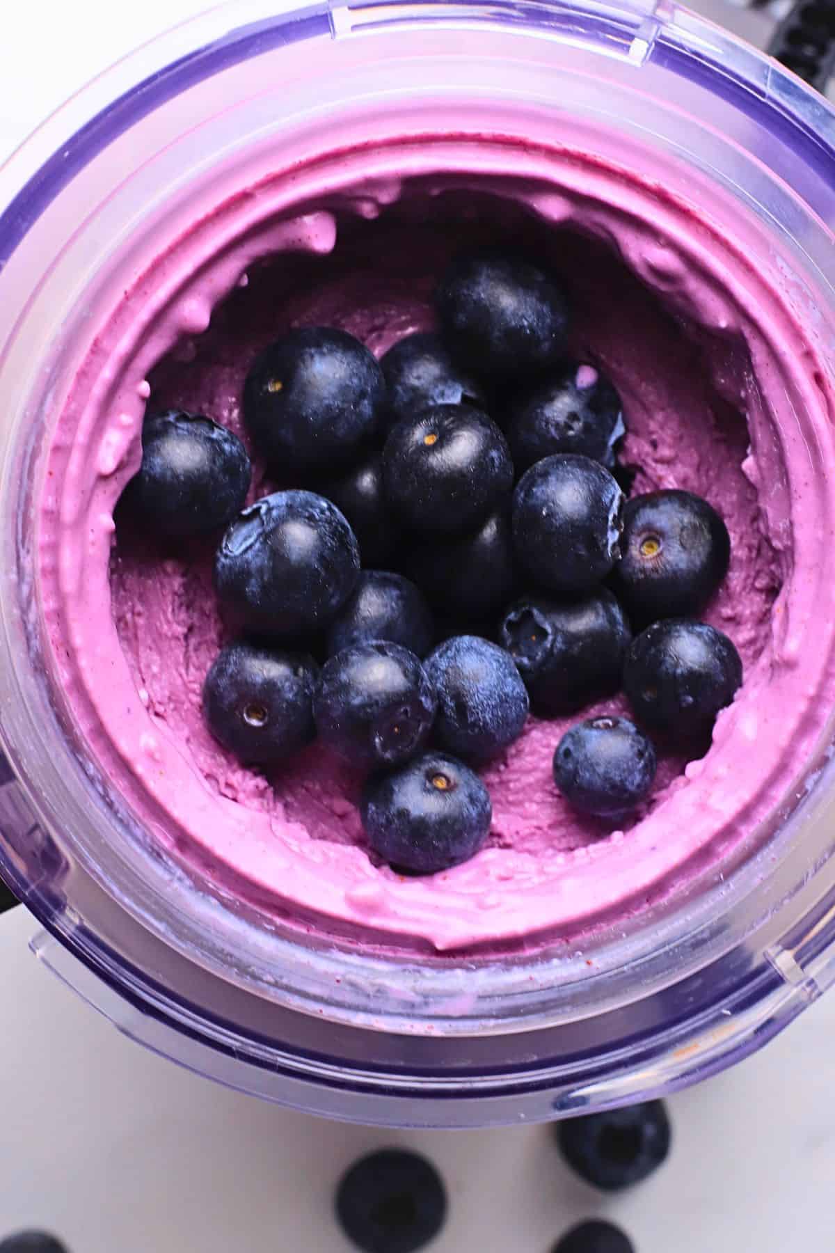 The ninja cream pint filled with the ice cream and topped with blueberries.