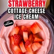 Low carb strawberry cottage cheese ice cream in a ninja creami pint topped with strawberries.