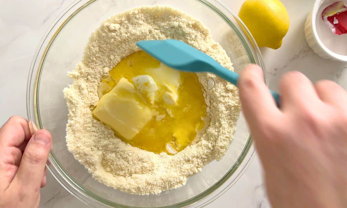 Mixing the wet and dry ingredients.