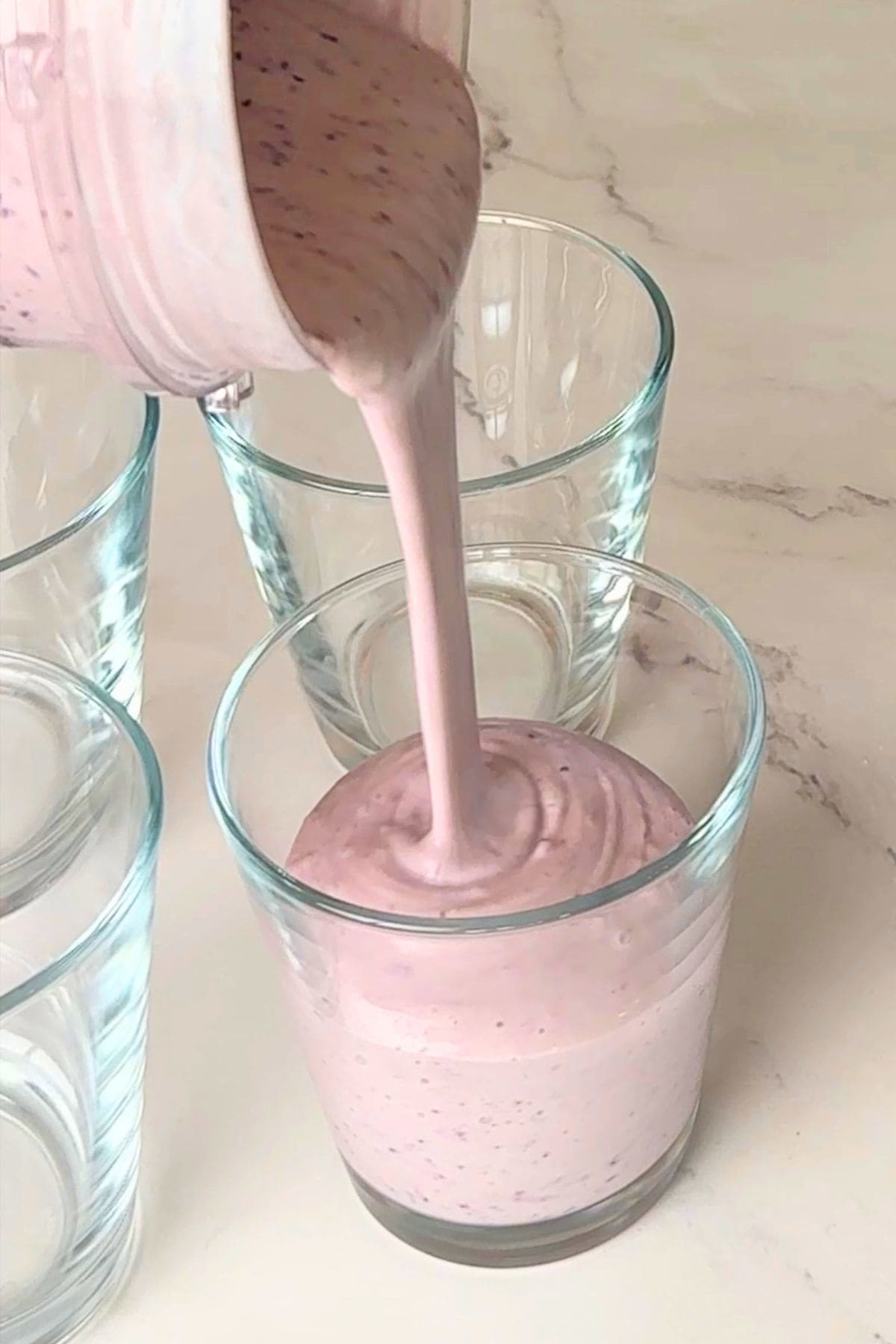 Pouring into a glass cup.