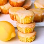 Sugar free lemon muffins stacked on top of each other next to a lemon.