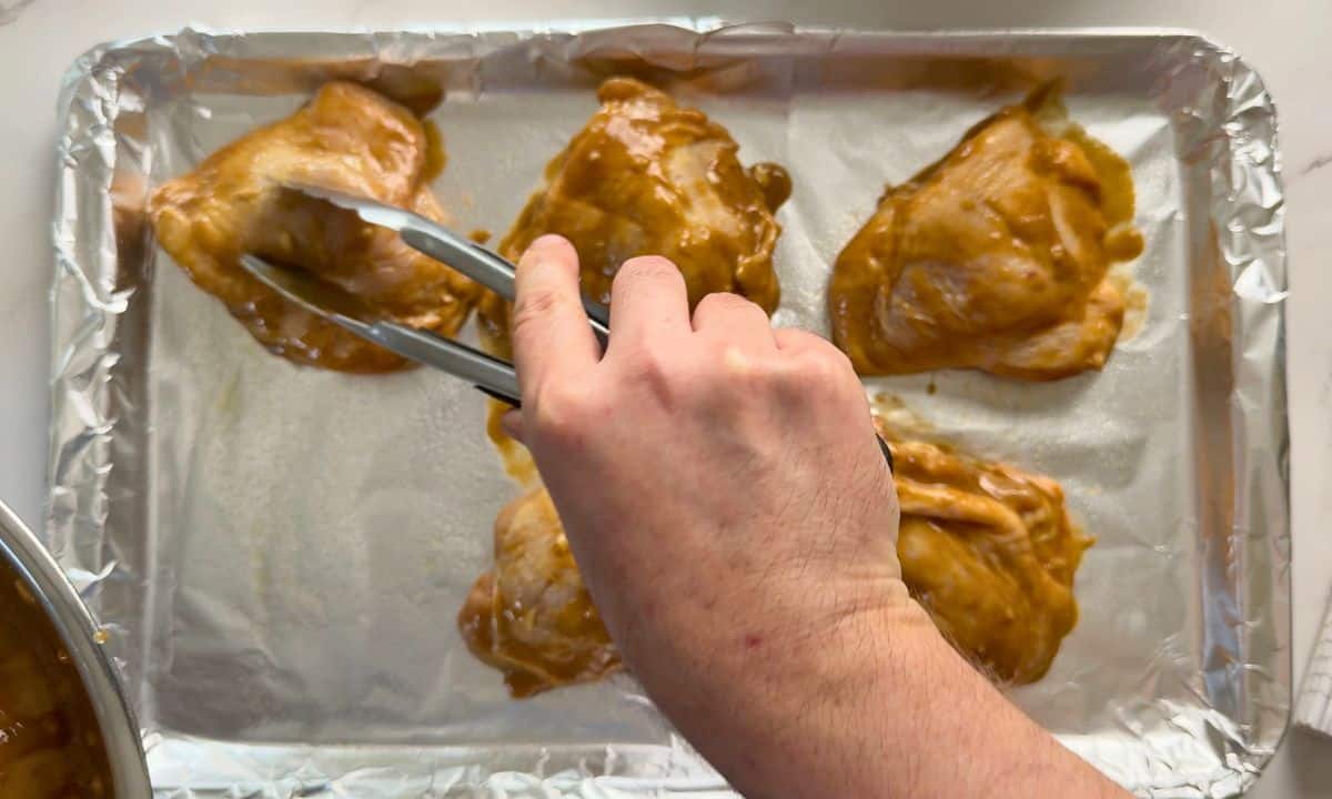 Sheet pan with marinated chicken.