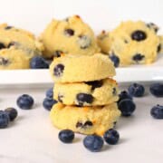 Three low carb blueberry cottage cheese cookies stacked on top of each other.